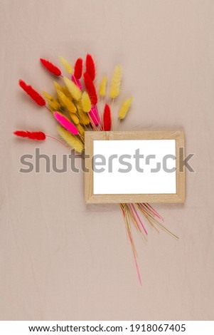 a photo frame with a decor of dried flowers on the background