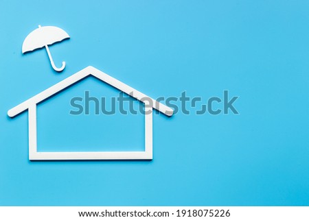 House Insurance, secure and protection concept. House shape under umbrella.