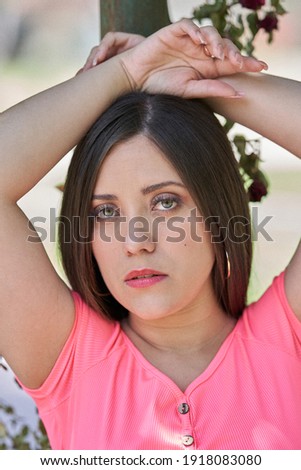 A beautiful white Latin woman posing and showing her beauty in a park