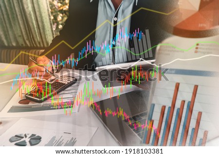 Businessmen are calculating their financial budgets with paper documents and calculators. Accounting expertise and documentation, graphs, marketing, analytics