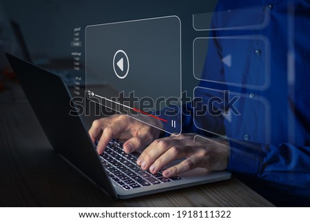 Video streaming on internet. Person watching online movie or TV series on laptop computer screen. Concept about subscription based live digital stream or channels, multimedia player with play button Royalty-Free Stock Photo #1918111322