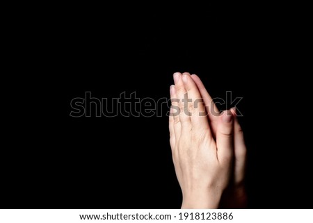 Praying hands with faith in religion and belief in God on blessing background. Power of hope or love and devotion in the dark with copy space , space for text Royalty-Free Stock Photo #1918123886