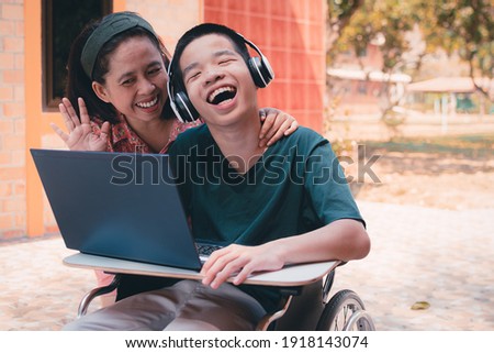 Special need child on wheelchair use a tablet in the house with his parent, Study or Work at home for safety from covid 19, Life in new normal education of special need kid,Happy disabled boy concept. Royalty-Free Stock Photo #1918143074