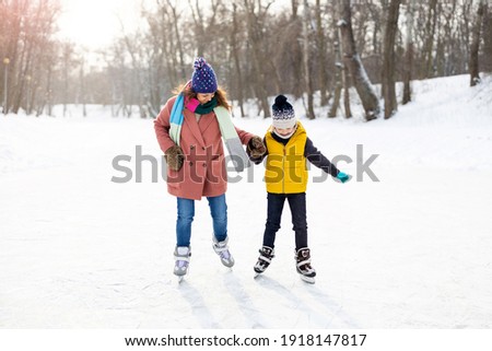 Mother and son ice skating
