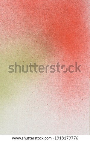 spray paint red and gree on a white paper background