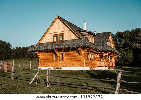 Wooden cottage in nature in sunny day. Recreation center in the mountains. Modern eko hausing in nature.
