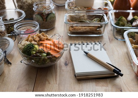 Batch cooking scene with an empty spiral menu notebook. Royalty-Free Stock Photo #1918251983
