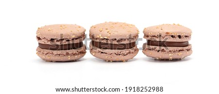 three cake of macarons or macaroons brown color. Delicious chocolate macaroons isolated on white background. French sweet cookie.