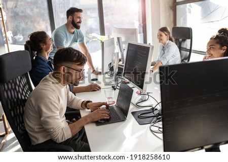 Group of designers programmers working on a new project at the office.	 Royalty-Free Stock Photo #1918258610