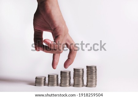 Coins a men's hand placed and sorted coins on a isolated white background