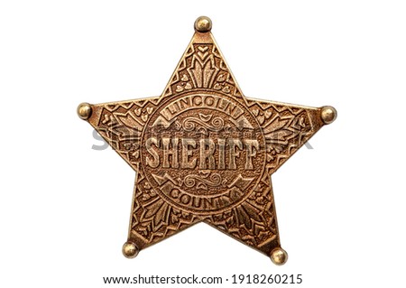 Law and justice in the wild west, American western culture and legal authority concept with picture of metal sheriff badge isolated on white background with clipping path cutout Royalty-Free Stock Photo #1918260215
