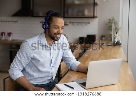 Motivated black man in headphones spend time for distant learning talk to teacher group mates on web conference. Confident biracial guy student get personal video consultation from tutor by video call