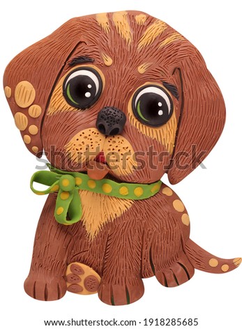 
little puppy with a bow on a white plasticine background