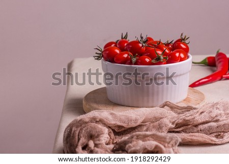 Fermented red cherry tomatoes in a white plate. Vegetarian food. Salted tomatoes. Pickled organic tomatoes. Homemade fermented foods. Food stocks