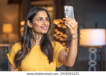 Beautiful Asian Indian woman taking a selfie.