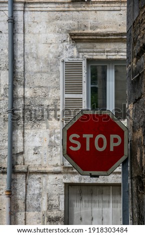 
STOP sign in a narrow street in a historic French town