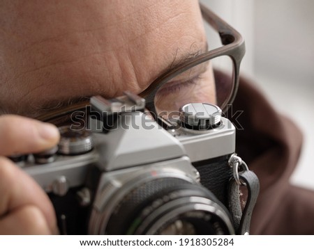 Photographer aims at the subject with the camera