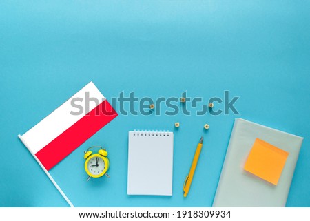 Time to learn foreign language. Flat composition for Polish courses with space for text on blue background. Royalty-Free Stock Photo #1918309934