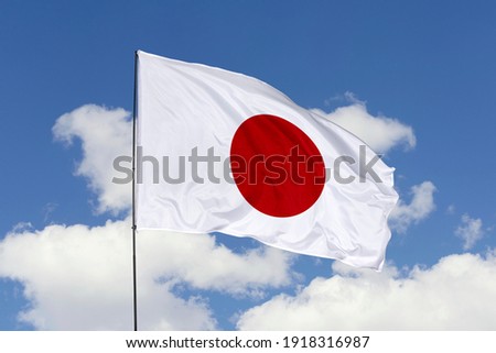 Japan flag isolated on the blue sky with clipping path. close up waving flag of Japan. flag symbols of Japan.