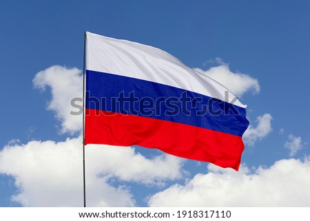 Russia flag isolated on the blue sky with clipping path. close up waving flag of Russia. flag symbols of Russia. Royalty-Free Stock Photo #1918317110