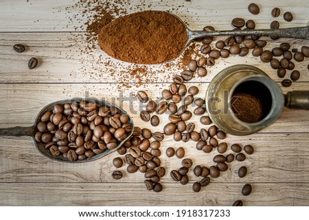 Coffee beans roasted on grunge wooden background.