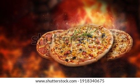 Pizza levitated in front of a burning oven. surrounded by flames