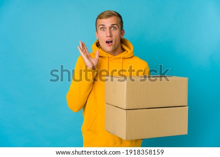 Young caucasian man doing moving over isolated background surprised and shocked.