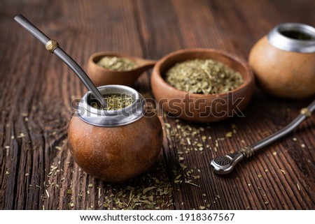 Healthy infused drink, classic Yerba Mate tea in a gourd with mobilla on wooden background Royalty-Free Stock Photo #1918367567