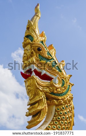 Golden Naga Statue with clear blue sky, Thailand 