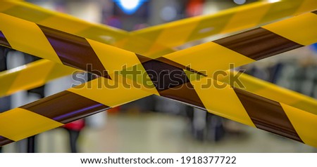 Barrier tape for prohibiting entry into the quarantine zone. Don't cross the belts. Yellow and black hazard ribbons Royalty-Free Stock Photo #1918377722