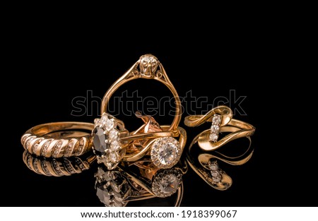 A golden scrap of old gold jewelry on black background
