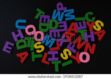 Color alphabet on black background