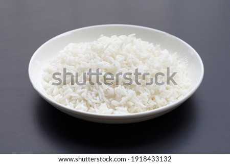 Dish of rice on dark background. Royalty-Free Stock Photo #1918433132