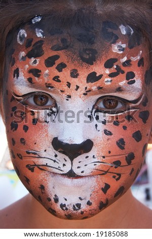 cute girl kid face with painted panther color mask