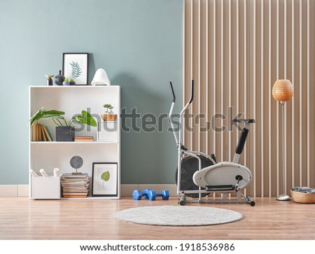Sportive and training room, nobody, green wall background, bookshelf frame and wooden chair concept.