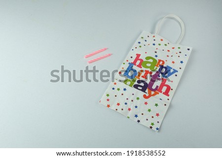 Birthday gift paper bag isolated on white background with selective focus.