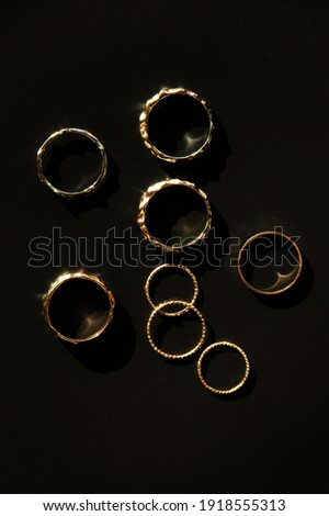 Luxury golden rings on the black background, Flat lay, Top view, ring photo.