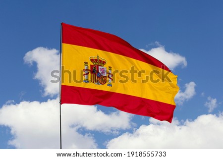 Spain flag isolated on the blue sky with clipping path. close up waving flag of Spain. flag symbols of Spain. Royalty-Free Stock Photo #1918555733