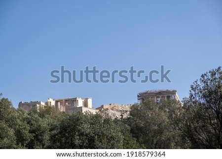 Acropolis of Athens Greece rock and Parthenon on blue sky background, sunny day. View from Dionisiou areopagitou street Royalty-Free Stock Photo #1918579364