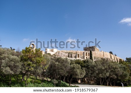 Acropolis of Athens Greece rock and Parthenon on blue sky background, sunny day. View from Dionisiou areopagitou street Royalty-Free Stock Photo #1918579367
