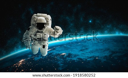 Astronaut spaceman do spacewalk while working for space station in outer space . Astronaut wear full spacesuit for space operation . Elements of this image furnished by NASA space astronaut photos. Royalty-Free Stock Photo #1918580252