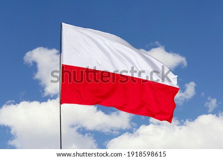 Poland flag isolated on the blue sky with clipping path. close up waving flag of Poland. flag symbols of Poland.