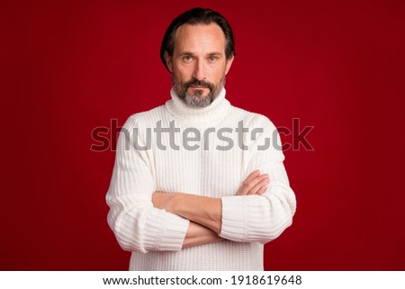 Photo of mature handsome good looking serious businessman in turtleneck with folded arms isolated on red color background