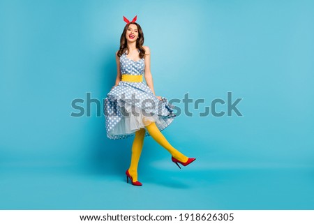 Full length body size view of her she nice attractive lovely fashionable glamorous cheerful cheery wavy-haired girl dancing having fun isolated on bright vivid shine vibrant blue color background