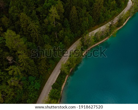 Aerial top down view of road near Lake Bled. Cloudy weather, heavy thunderstorm clouds on the horizon. Copy space. Season of tour and travel. Triglav, Slovenia, Europe