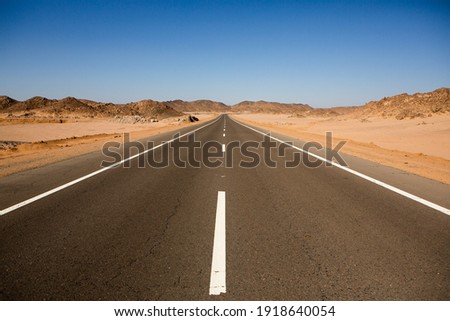 Road in the sahara desert of Egypt. Conceptual for freedom, enjoying the journey. Empty road. Freeway, Highway through the desert Royalty-Free Stock Photo #1918640054