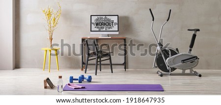Training and sportive room, grey interior style, stone wall, bike and purple mat, blue dumbbell.