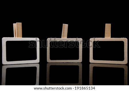 Three wooden clothes clip isolated with black background