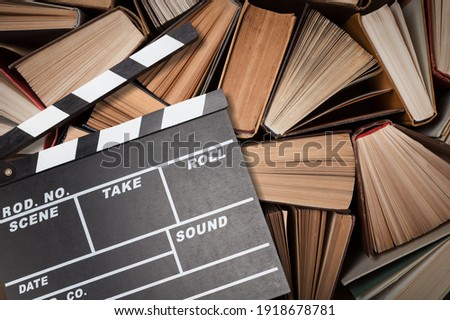 Movies adapted from books, cinema concept with clapboard and book