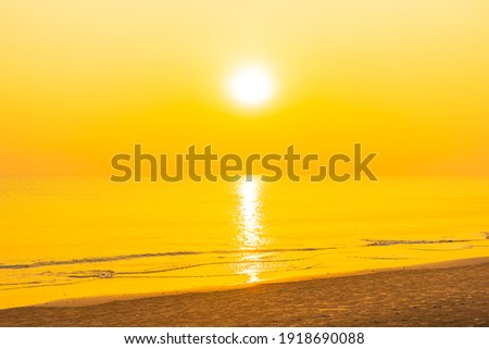 Beautiful tropical beach sea ocean at sunset or sunrise time